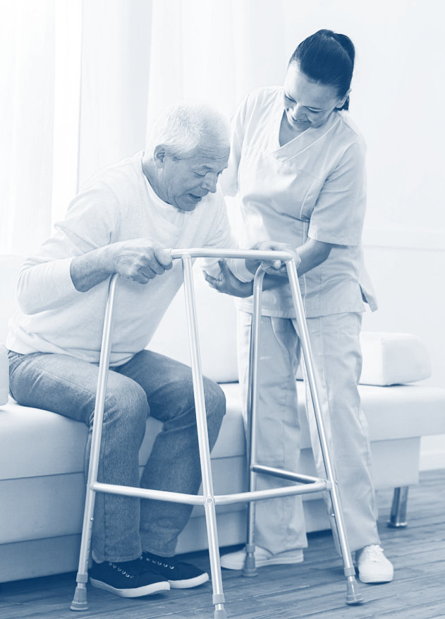 caregiver assisting a senior man to stand up using the walking frame